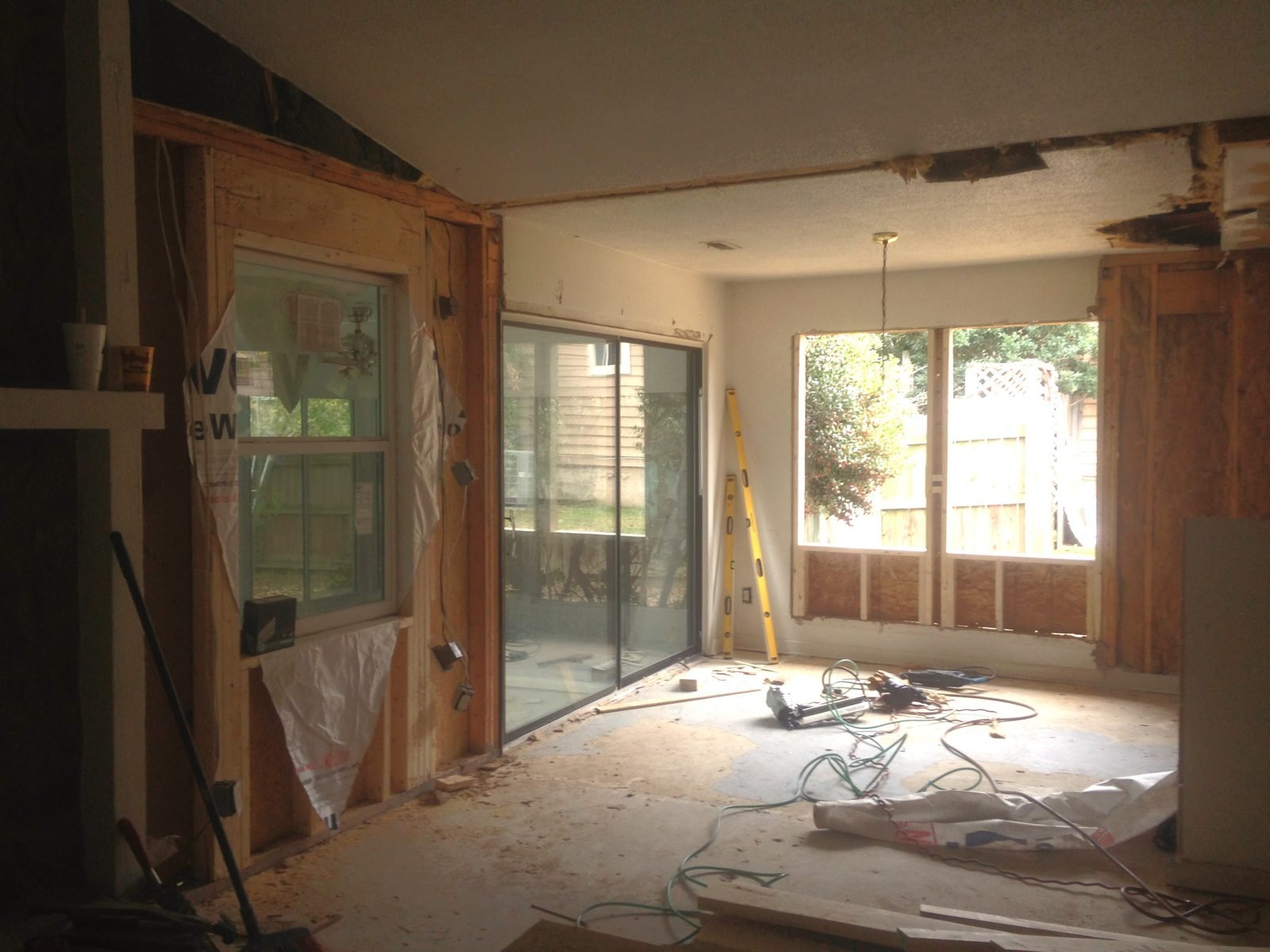 Interior demolition in progress at a foreclosure property renovation, walls opened to the studs.